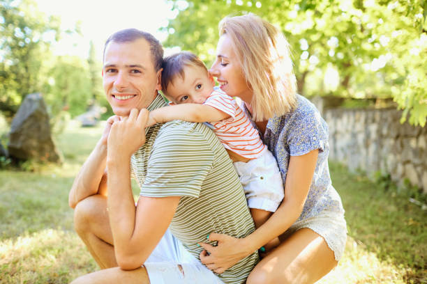 istock Happy family smiling playing in summer park. 838899258