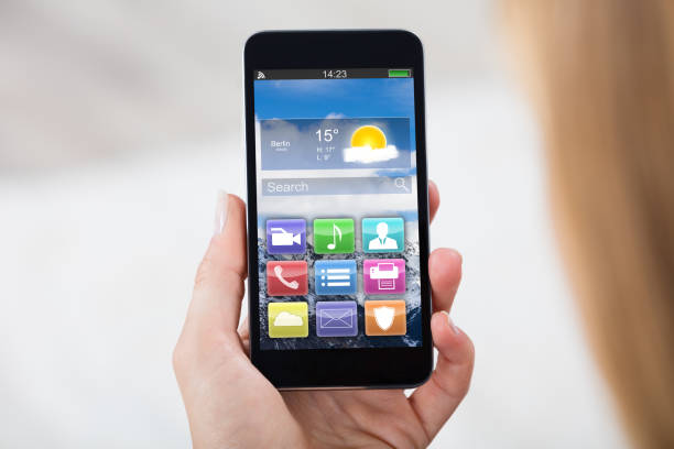 Close-up Of Woman Hand Holding Mobile Phone Showing Different Colorful Application