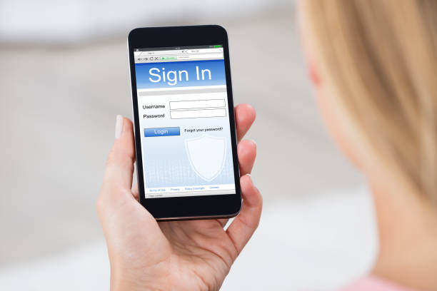 istock Woman Holding Mobile Phone Showing Log In Page 838902960