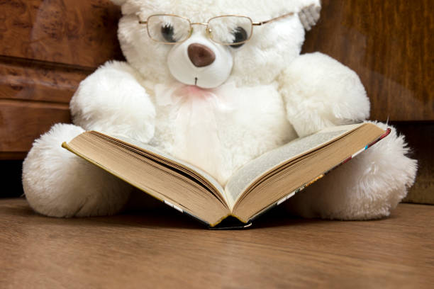istock white bear toy with glasses glasses reading a book 838903164