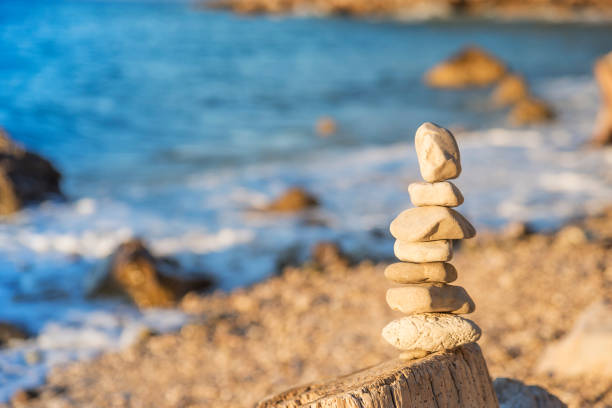 istock Pyramid of pebbles on the sea coast 838903304