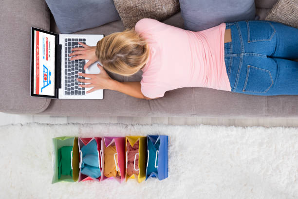 istock Woman Lying On Sofa Using Laptop For Shopping Online 838906802