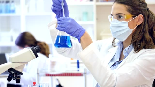 Young female scientist conducts research in laboratory