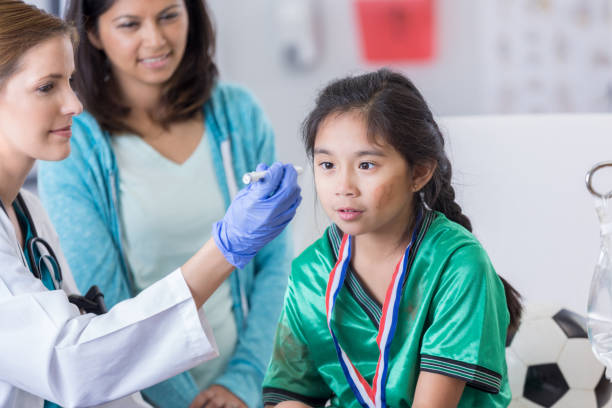 istock Emergency room doctor examines young dazed soccer player 838910378