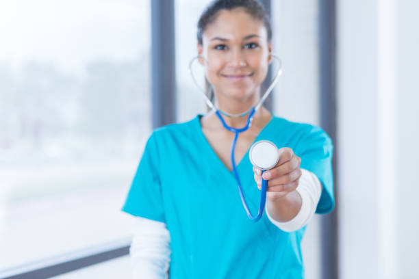 istock Confident nurse holds out stethoscope 838910480