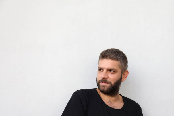istock Cheerful young man smiling and looking up on white background 838910728