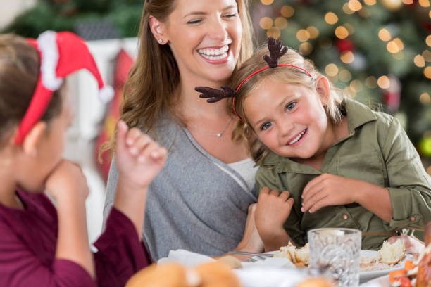 istock Happy mom enjoys Christmas with her daughters 838910938