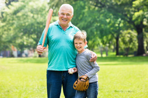 Grandson And Grandfather Playing Baseball Kid Playing Baseball Game With Grandfather In Garden old baseball stock pictures, royalty-free photos & images