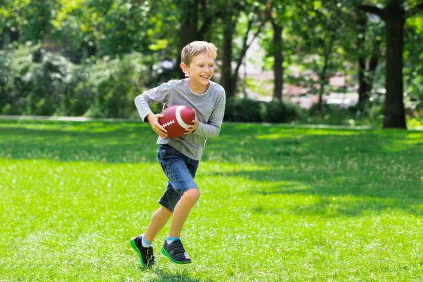 istock Boy Running With Rugby Ball 838917212
