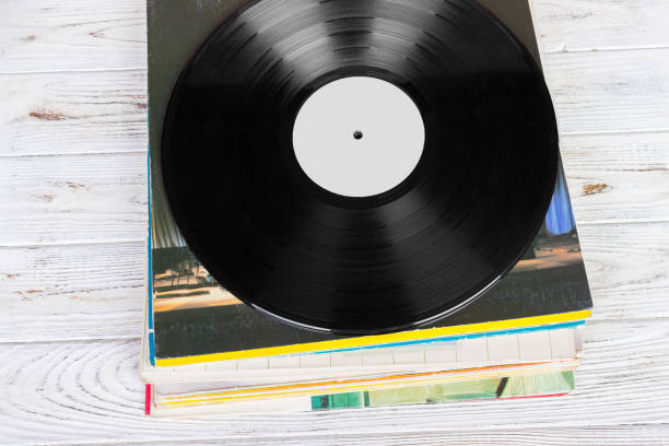 istock Black vinyl records on the wooden table, selective focus with copy space. Top view 838917648