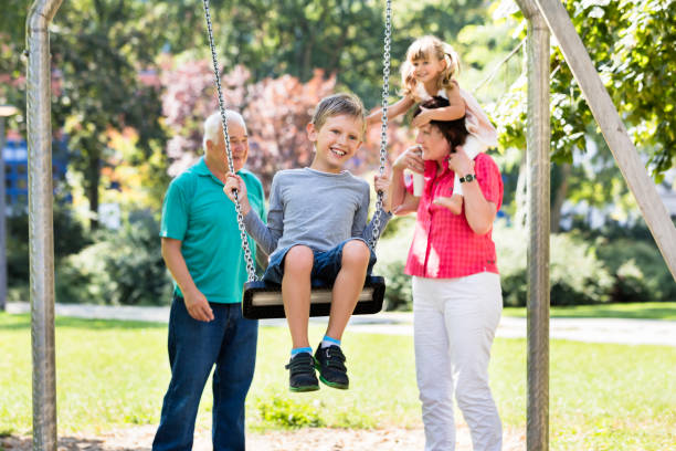 istock Grandson Enjoying On Swing In The Park 838917692