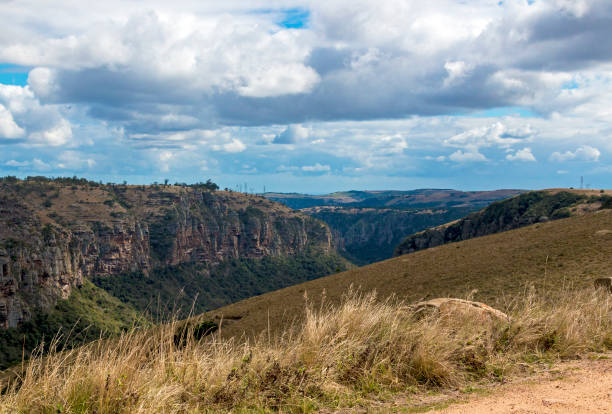 istock Dry Grassland Gorge Mountains and Valleys Against  Cloudy Sky 838917930
