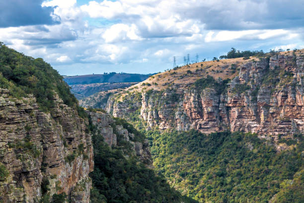 istock Green Trees  Gorge Mountains and Valleys Against  Cloudy Sky 838917932