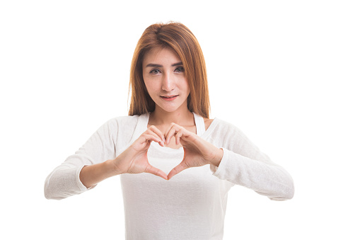 Young Asian woman show heart hand sign  isolated on white background
