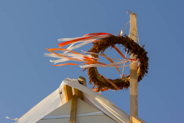 topping out wreath on a roof construction, against blue sky, Holl, Denmark, August 23, 2017