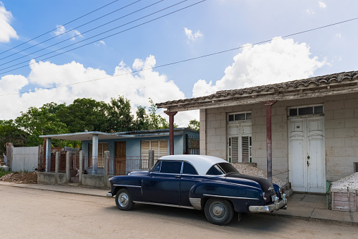 Santa Clara: Street life view with a parked blue american Chevrolet classic car on the side street in Santa Clara Cuba - Serie Cuba Reportage