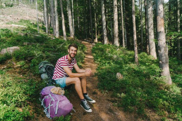 istock Man resting after hiking in forest covered with moss in mountains 838924086