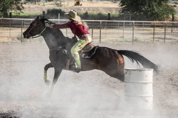 istock At a rodeo, cowgirl on her horse aiming at completing a cloverleaf pattern during the barrel racing event, also called Gymkhana. 838926724
