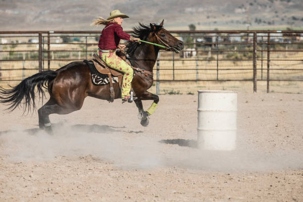 istock At a rodeo, cowgirl on her horse aiming at completing a cloverleaf pattern during the barrel racing event, also called Gymkhana. 838926738