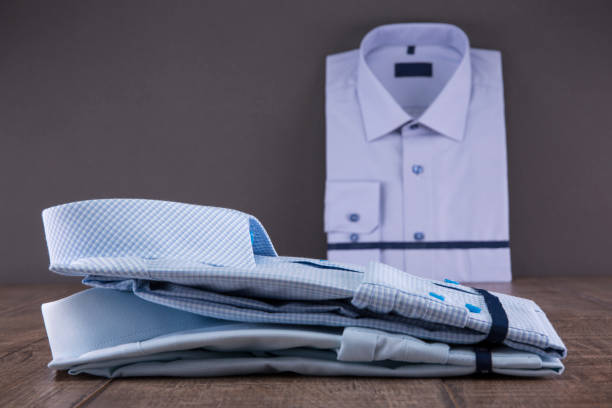 istock Men's shirts on a wooden table. Folded. The background is gray. 838940756