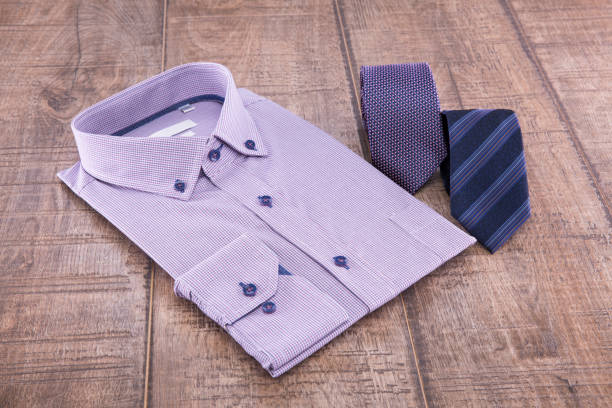 istock Man's shirt folded and two ties on a wooden background 838941058
