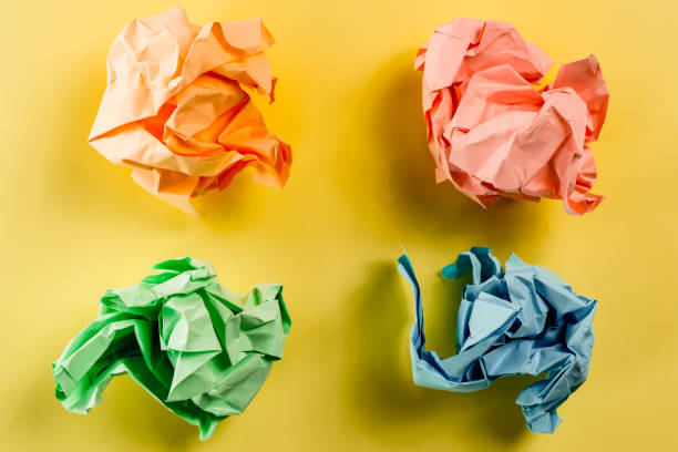 istock Crumpled multi colored paper ball on a plain paper 838941244