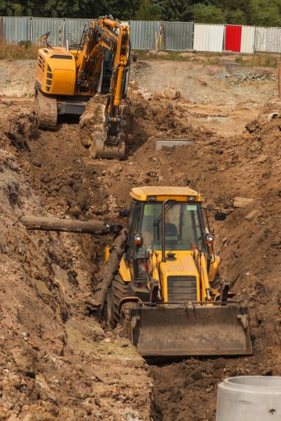 istock Construction of a new sewerage system. The bulldozer digs a trench for sewer pipes. Construction works. 838941992