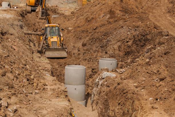 istock Construction of a new sewerage system. The bulldozer digs a trench for sewer pipes. Construction works. 838942200