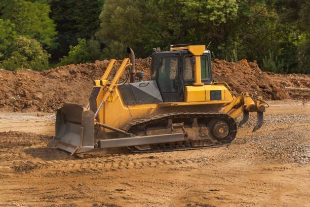 istock Excavator working on a construction site. Yellow Construction bulldozer at Work. Construction of a new road. 838942388