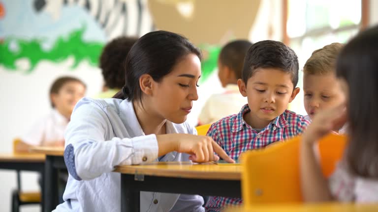 Teacher helping a student understand the task