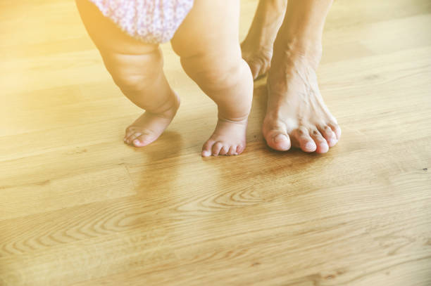 istock Baby's and mother's feet are walking. 838945592
