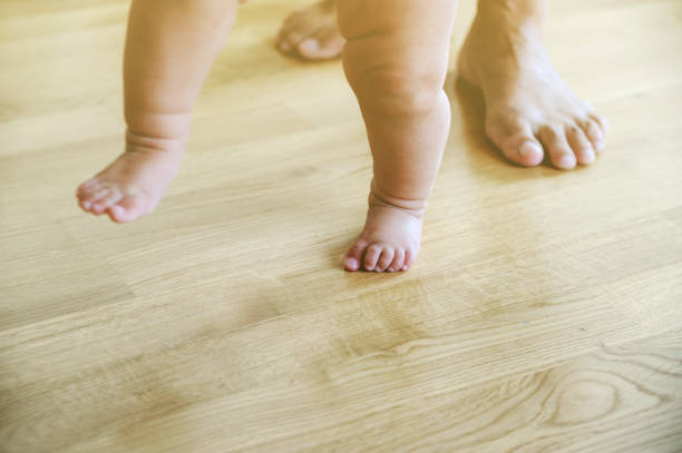istock Baby's and mother's feet are walking. 838945596