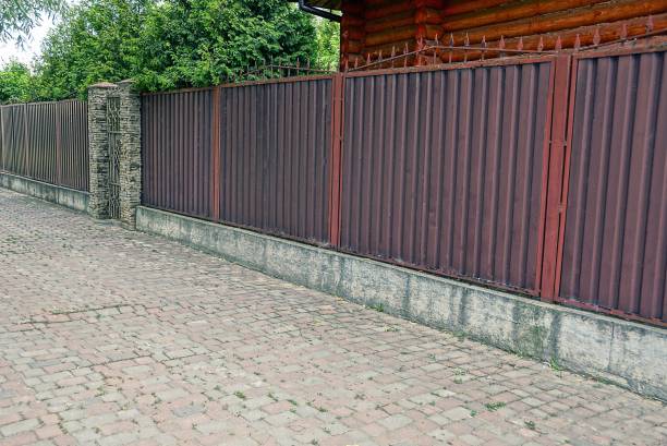 istock brown iron fence at the sidewalk 838946514