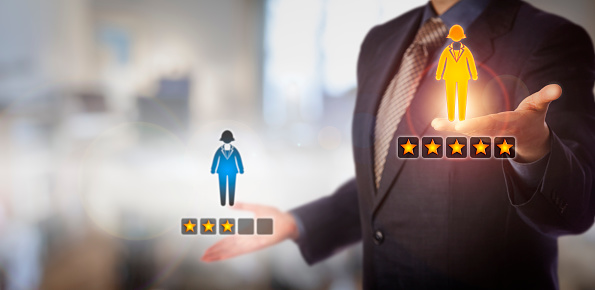 Unrecognizable manager is evaluating a female employee icon with a  five star rating versus one with three. HR concept for talent management, performance review, staffing decisions and achievement.