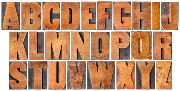 vintage alphabet set in wood type complete English alphabet - set of 26 isolated vintage wood letterpress printing blocks, scratched and stained by ink patina,  gothic bold extended font printing block photos stock pictures, royalty-free photos & images