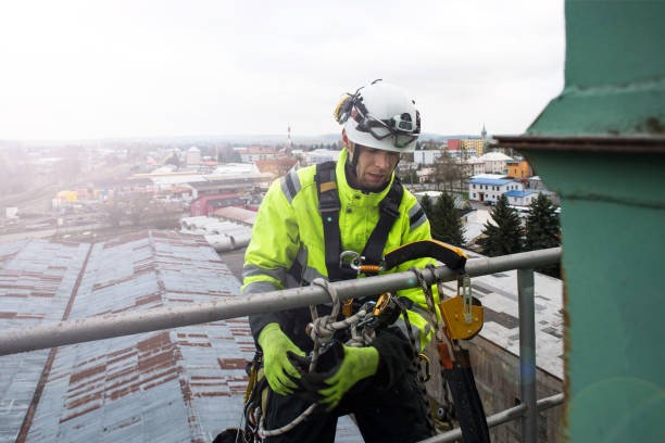 Manual high worker abseil from tower - antena in sunshine
