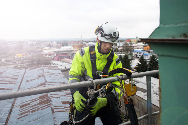 Manual high worker abseil from tower - antena in sunshine stock photo