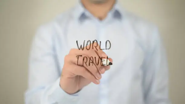 World Travel , man writing on transparent screen