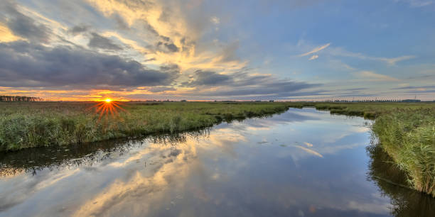 istock Sunset over river in  marshland nature reserve 838958812