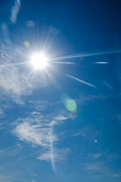 istock bright blue sky with the sun causing lens flare 838972330
