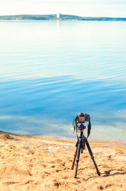istock A camera on a tripod on sea background 838972624