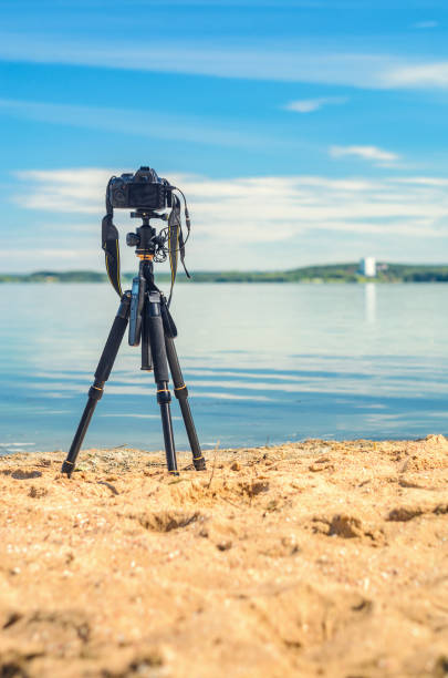 istock A camera on a tripod on sea background 838972644