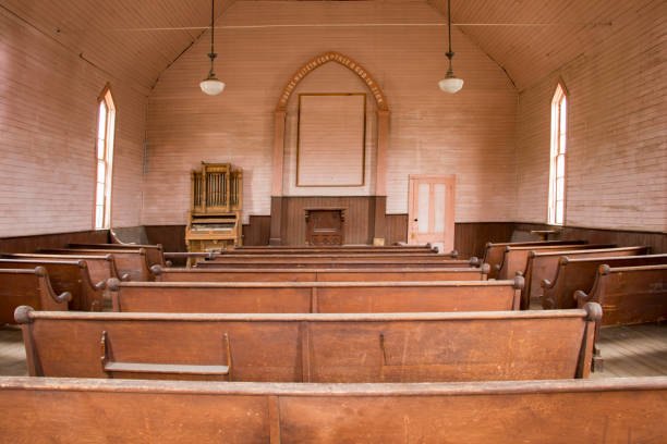 istock Wooden pews inside rustic wooden church 838980086