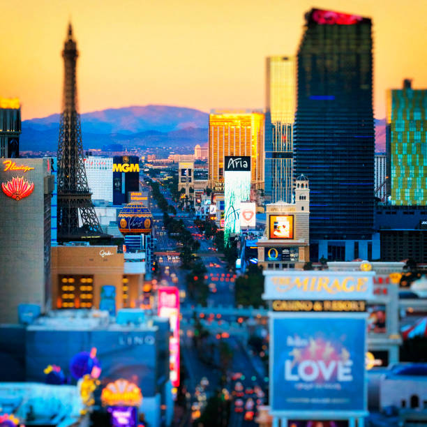 Las Vegas, Nevada - April 13, 2024: Vibrant night scene of Las Vegas Strip featuring Horseshoe and Eiffel Tower illuminated amidst bustling traffic.