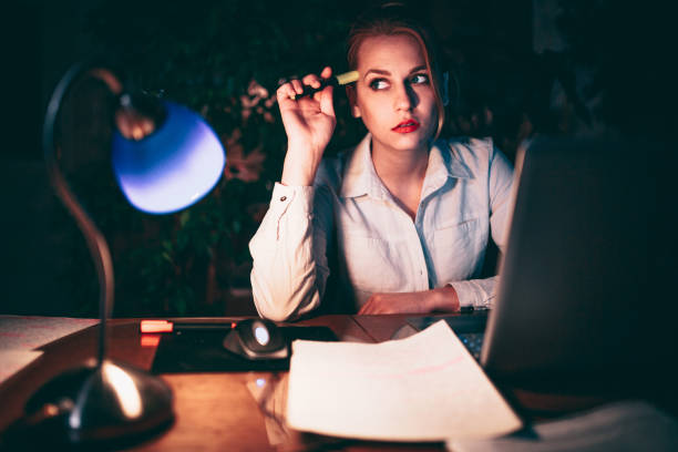 istock Beautiful young woman brainstorming late night 838985384