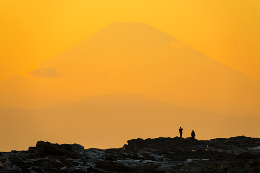 Silhouettes of people with Mt. Fuji in dusk