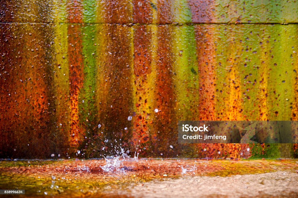 Rusted and Multi-colored Metal wall Evergreen Brick Works Aging Process Stock Photo