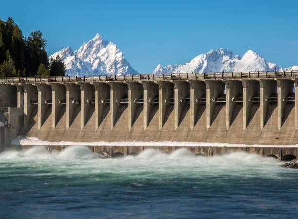 Jackson Lake Dam flowing water quickly in order to empty lake stock photo