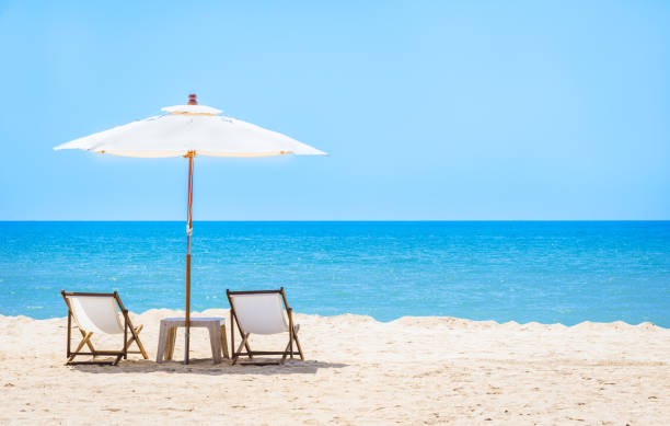 istock Beach chair with umbrella with blue sky on tropical beach. 839008128