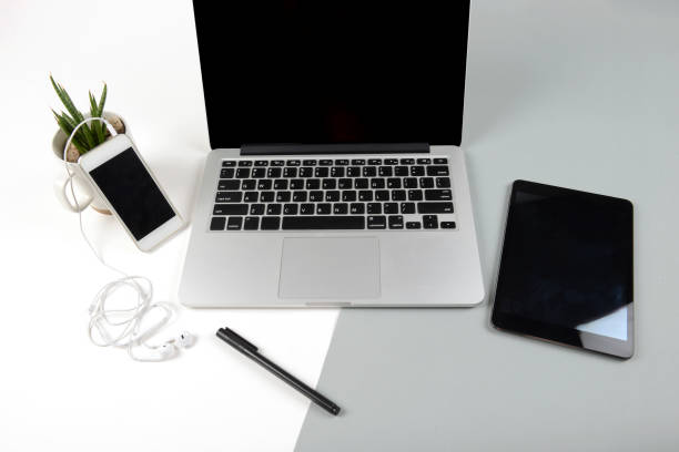 istock Office table with laptop computer, digital tablet and mobile phone on modern two tone (white and grey) background. 839017536